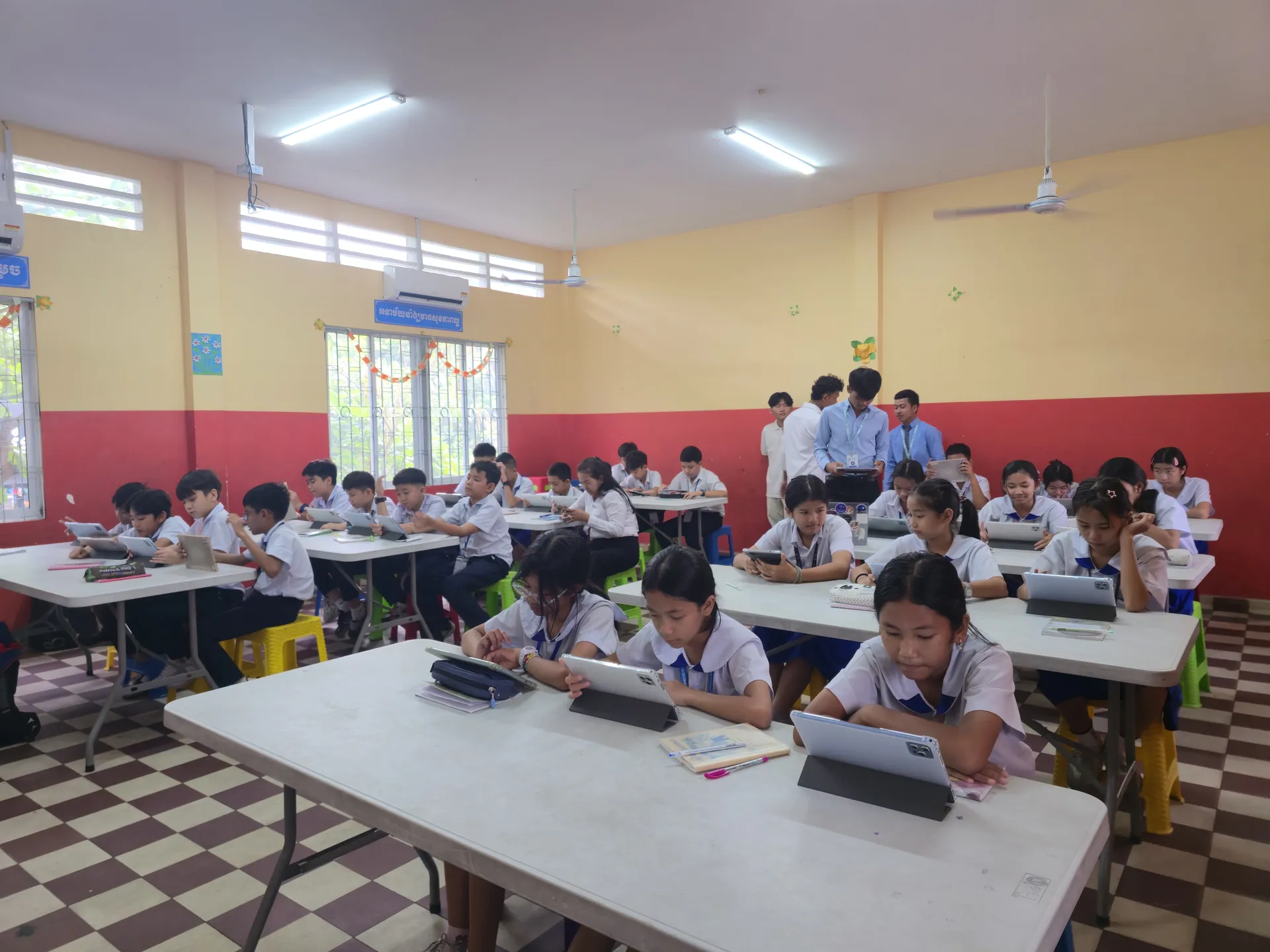 A Cambodian primary school classroom with every student reading on a tablet.